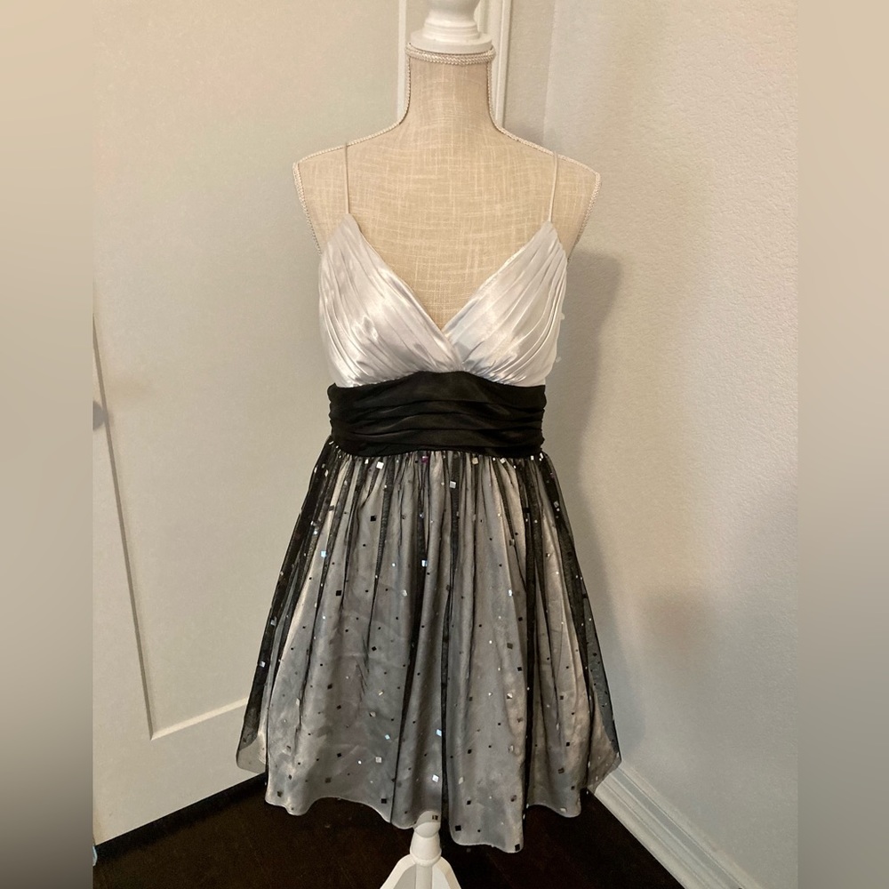 Black and white strapless dress with a puffy skirt and zipper in the back.